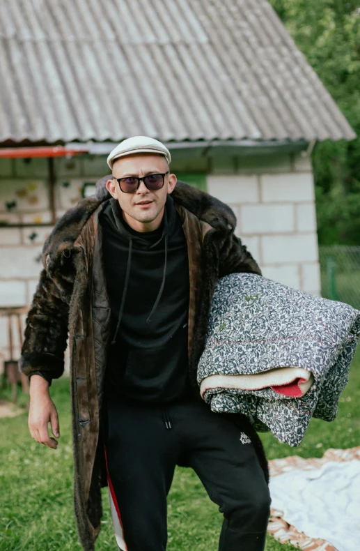 a man carrying a large object on his back