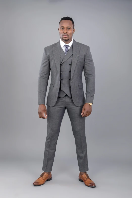 a man in a suit is standing and posing