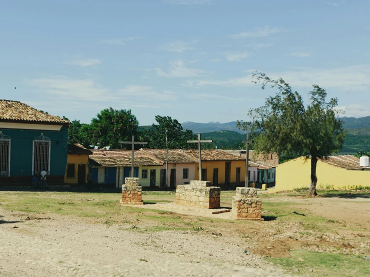 several small yellow and green houses with trees