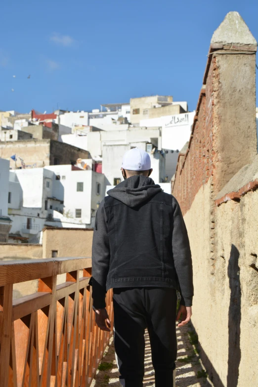 a person in a white hat is walking up a hill