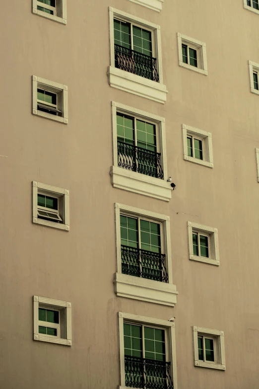 multiple windows are opened on the side of a large building