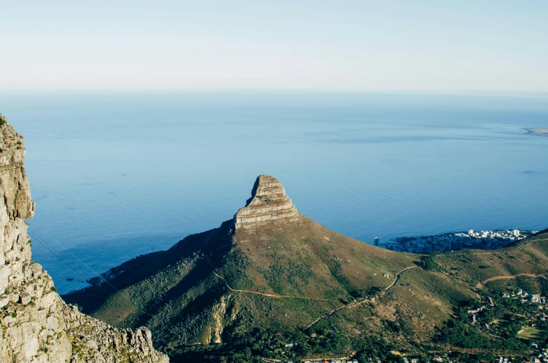 the view of a large mountain and ocean