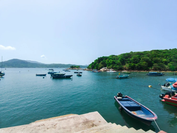 the water with boats is mostly calm from the sun