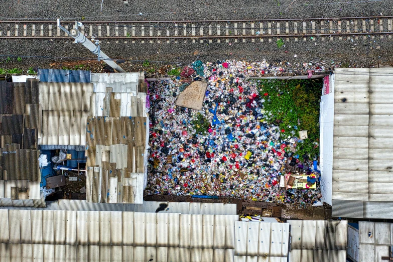 a city filled with lots of garbage and surrounded by tall buildings