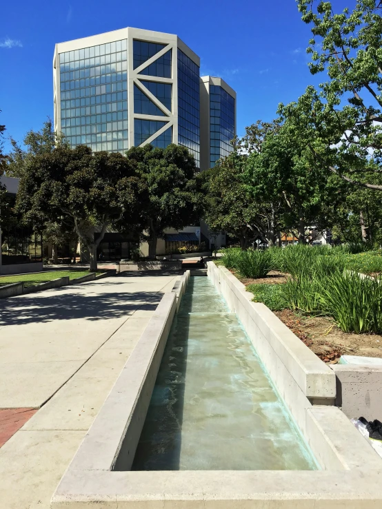 water features in front of glass buildings in an urban setting