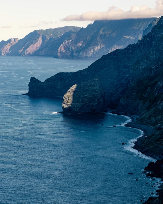 a view looking down onto the ocean from atop a cliff