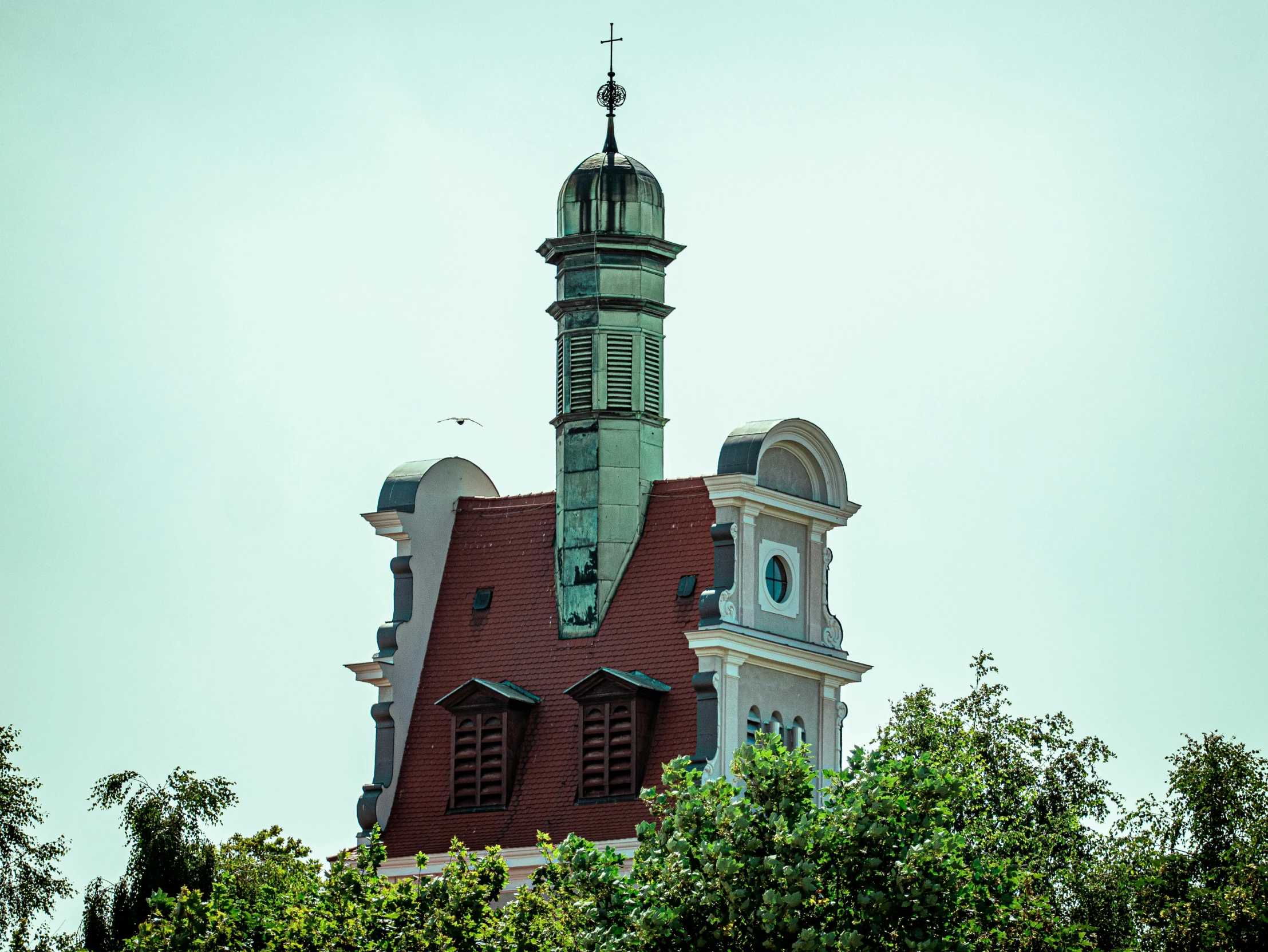 large brick building with a clock on top, with a steeple