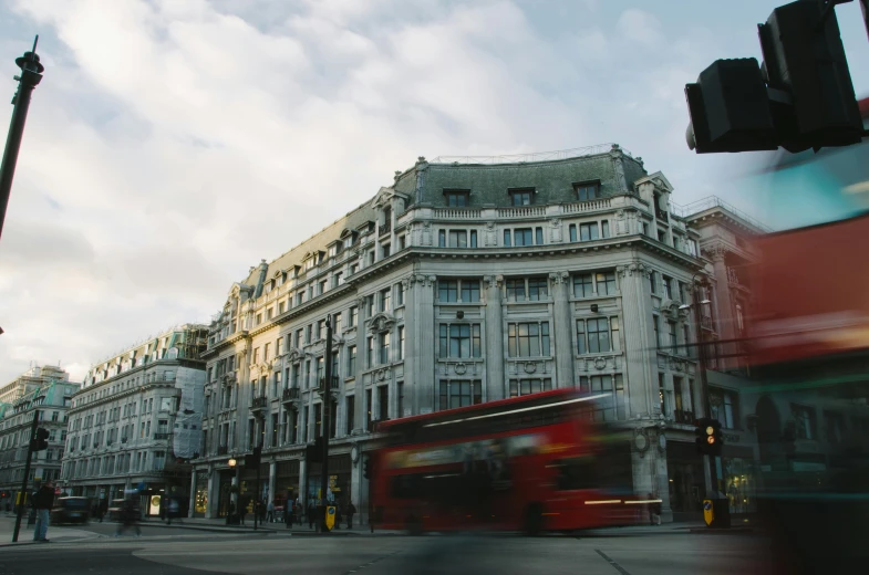 red bus on street with buildings behind it