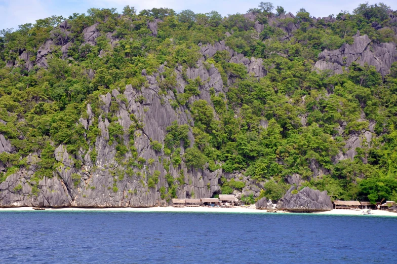 a view of some rocks and the ocean from across the sea