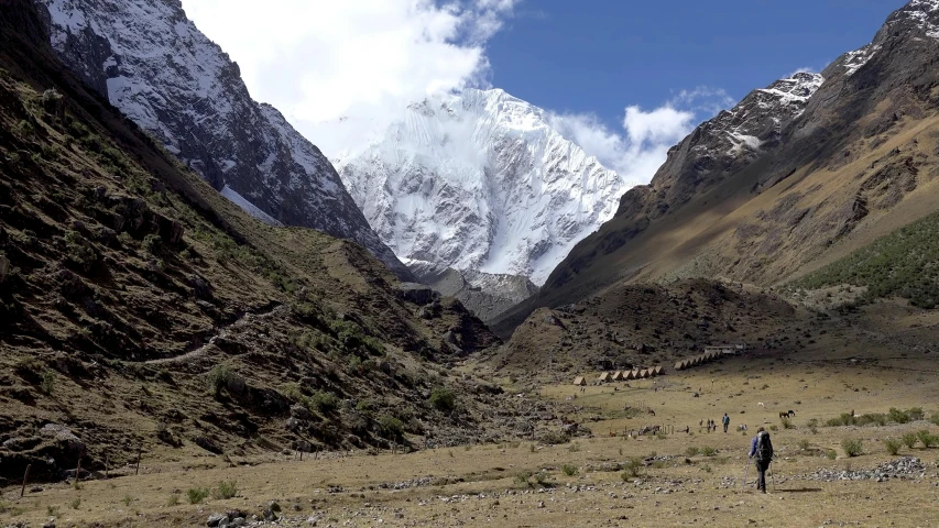 a man is walking alone near a mountain range