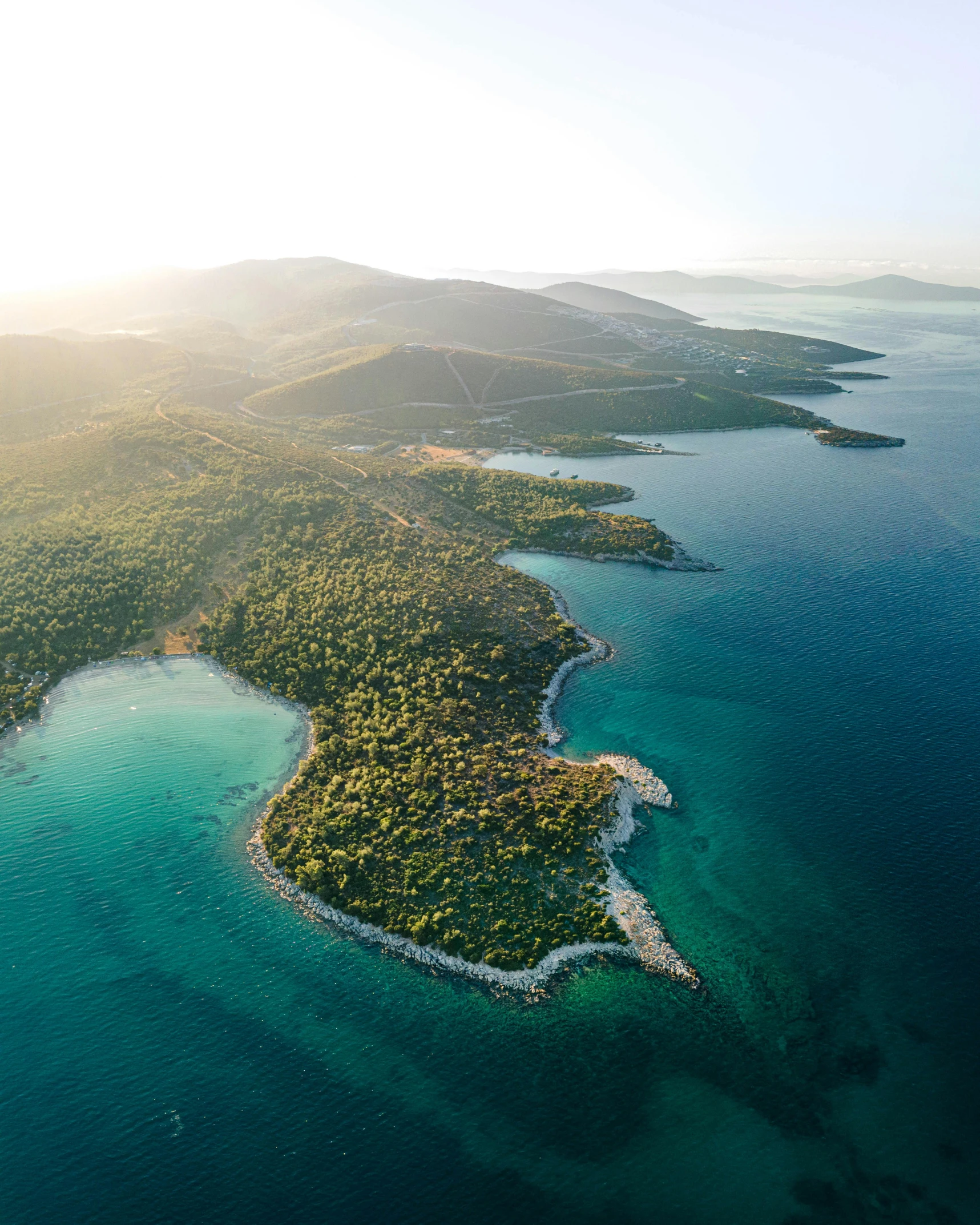 an aerial view of a tropical island surrounded by water