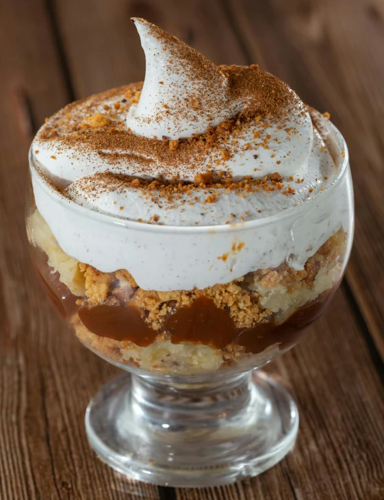 a dessert dish with marshmallows and icing, topped with brown sugar