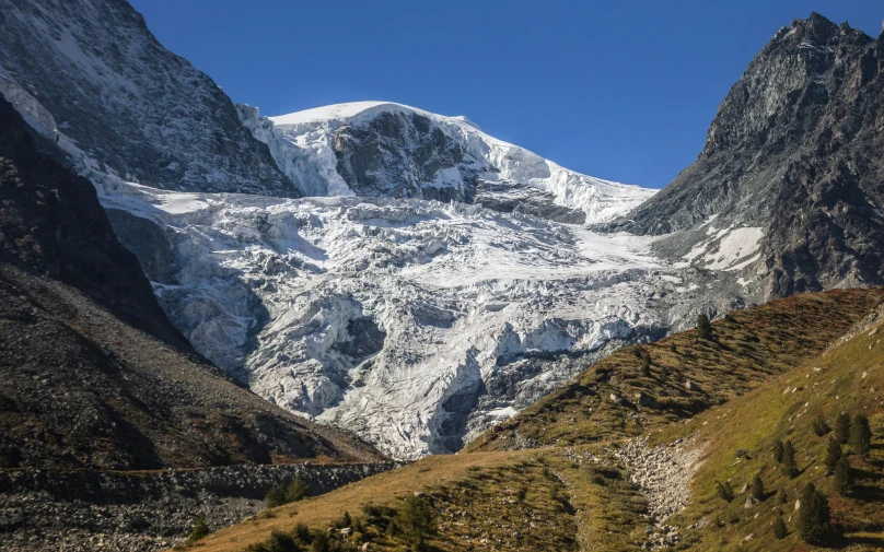 the mountain is covered with snow in the middle of it