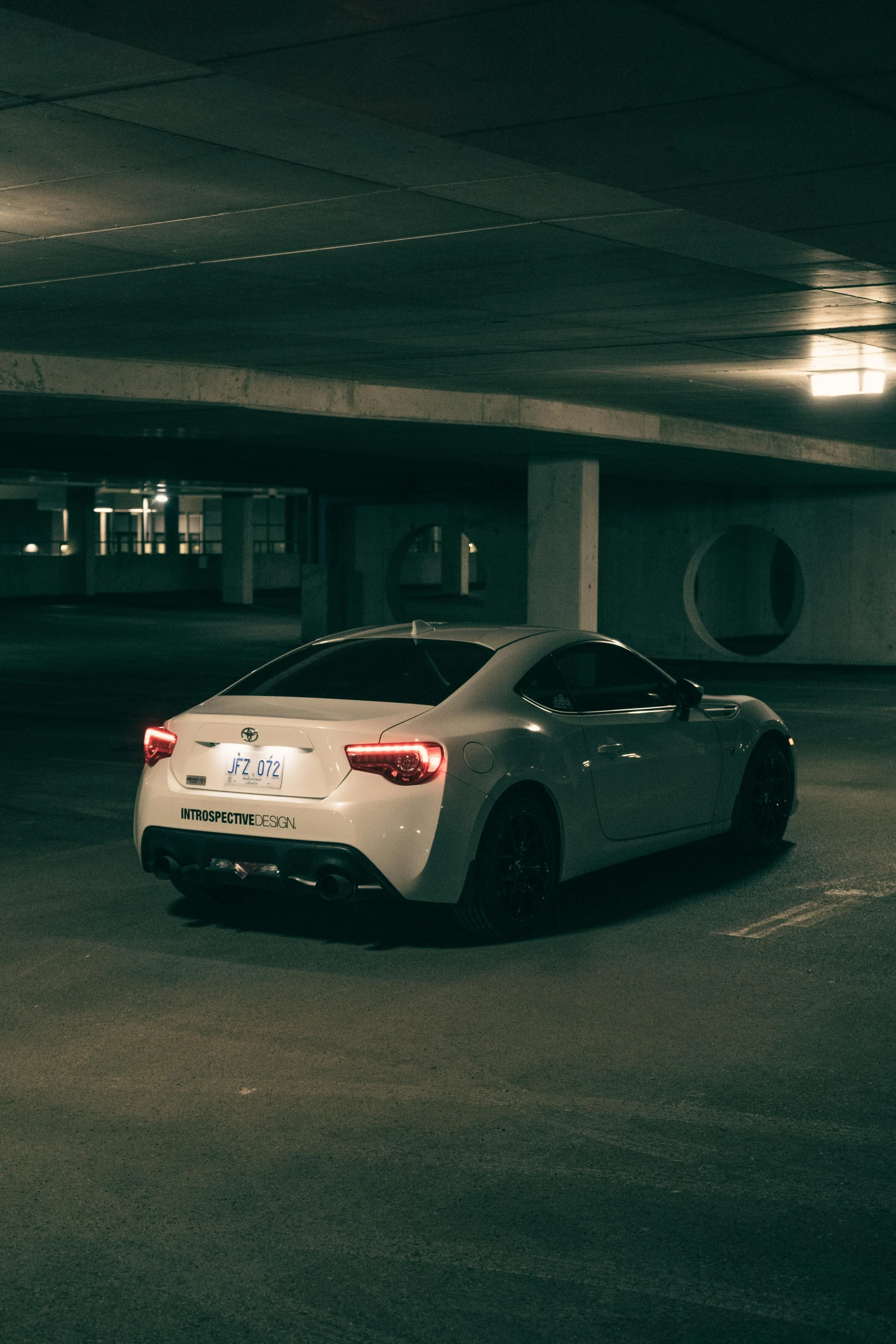 a car is parked inside of an empty parking garage