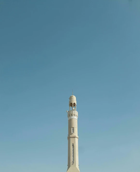 a large tower with a clock on top sits high in the sky