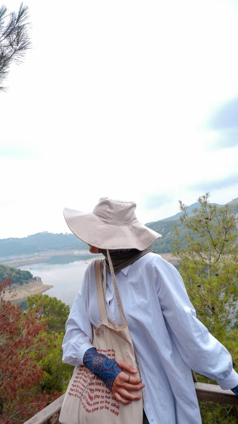 a person in white and blue carrying a purse over their shoulder