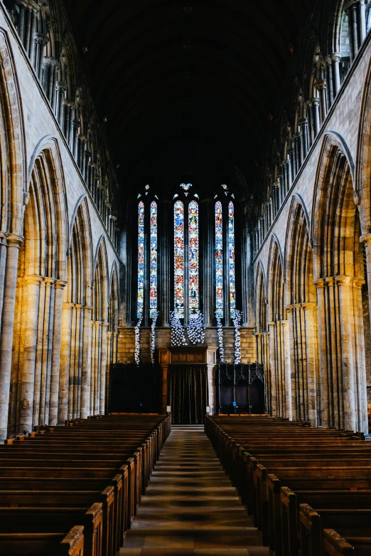 the interior of a cathedral showing all the pews and arches