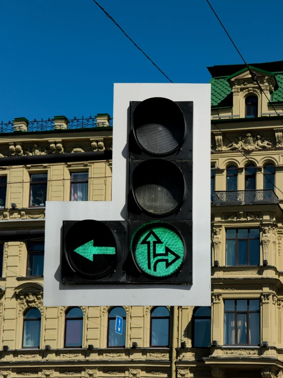 a stoplight with the green arrow lit up