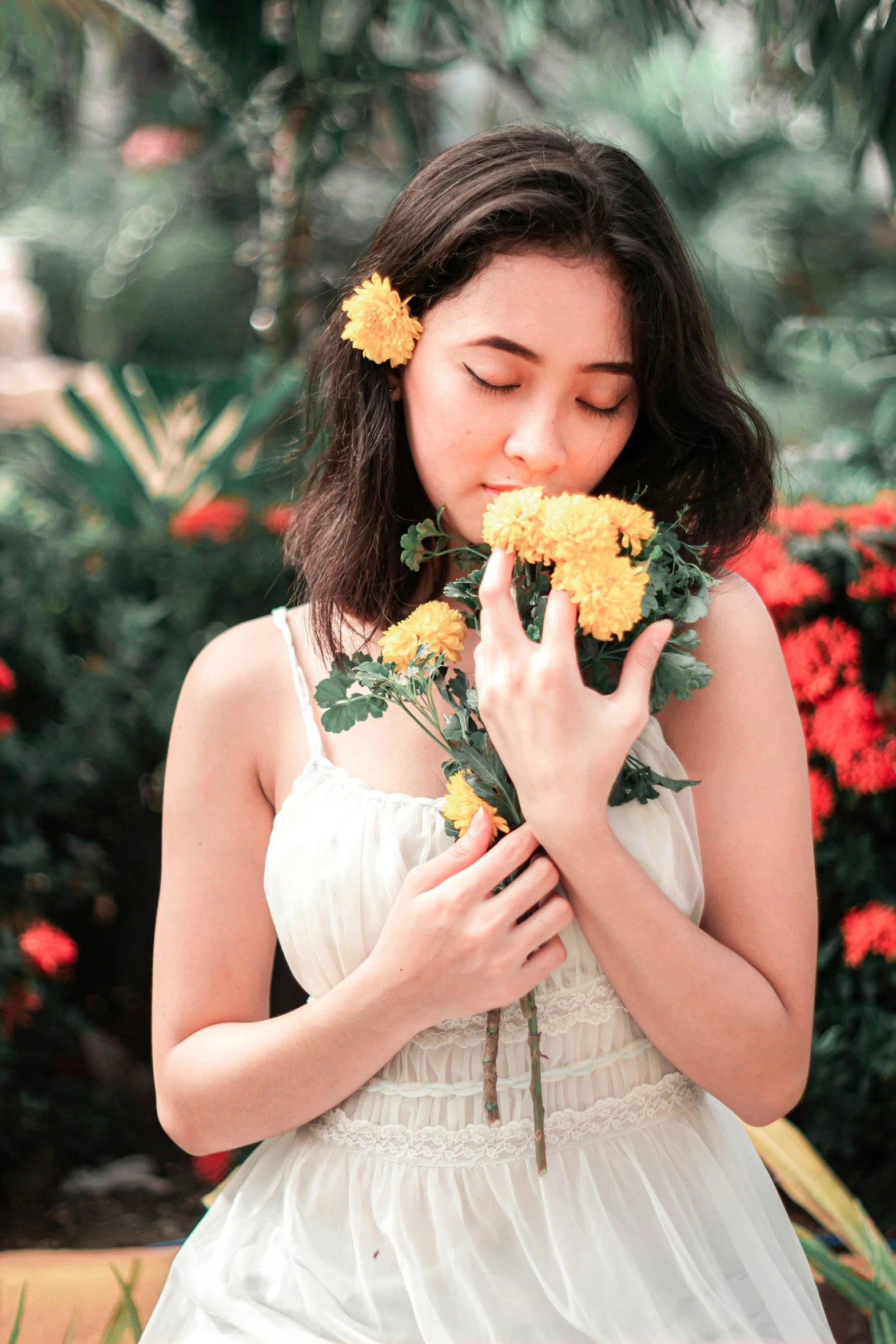 the  is smelling the flowers by her side