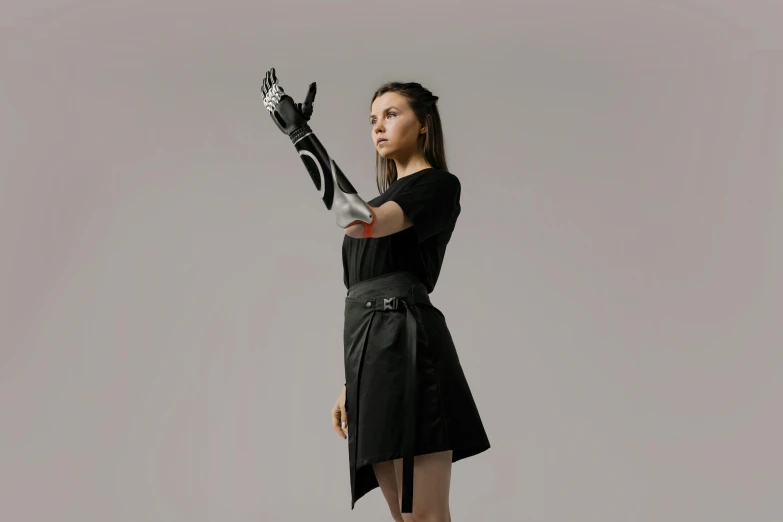 woman in black dress posing with white glove