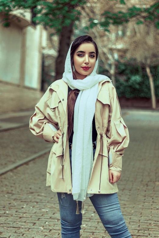 woman wearing beige clothes and scarf posing for po