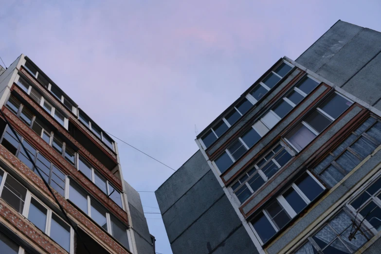 buildings in a city with lots of windows and some wires