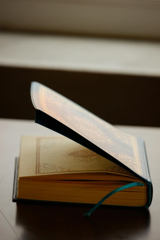 an open book sitting on a desk