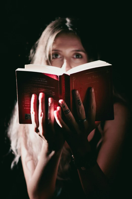 a woman is holding two books in her hands