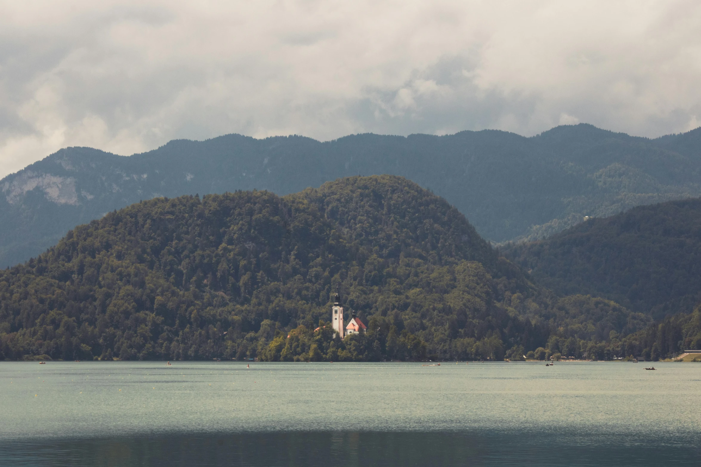 houses are on island in front of mountains