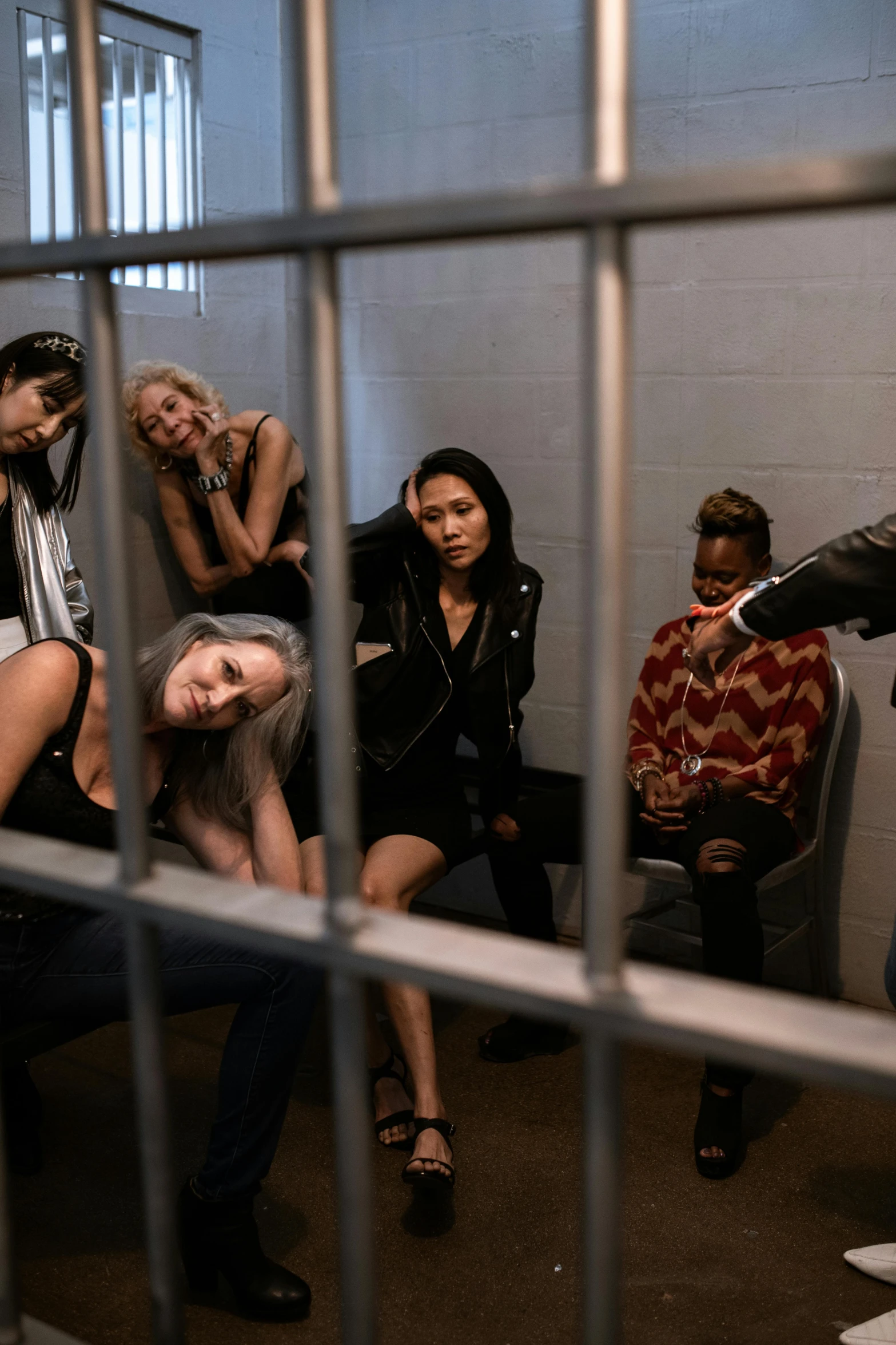 a group of women posing for a picture through bars