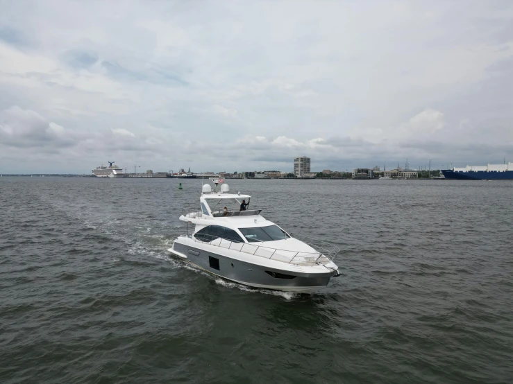 a motorboat moving across the ocean near some buildings