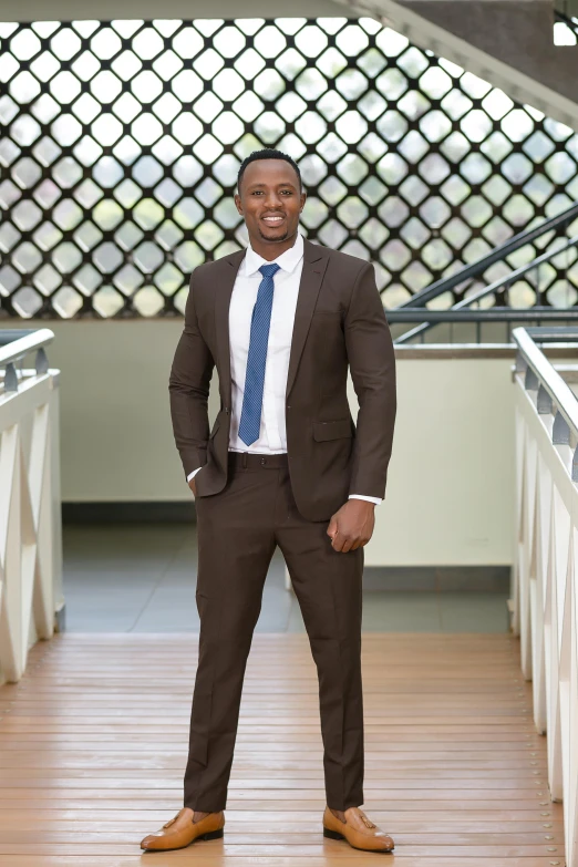 an african american businessman posing on a bridge