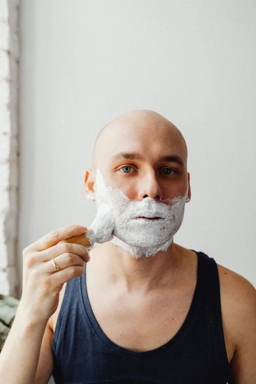 a man with his hair and beard trimmed shaveing