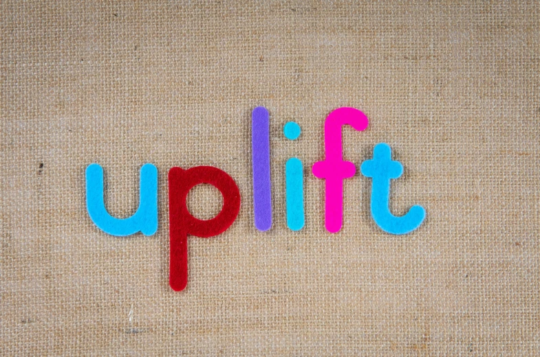 the word uplift is painted on to the fabric