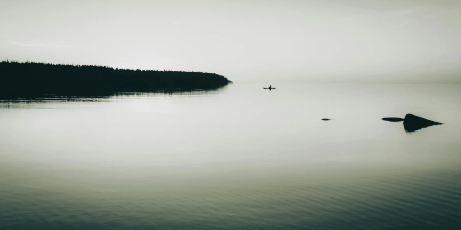 a large body of water sitting under a cloudy sky