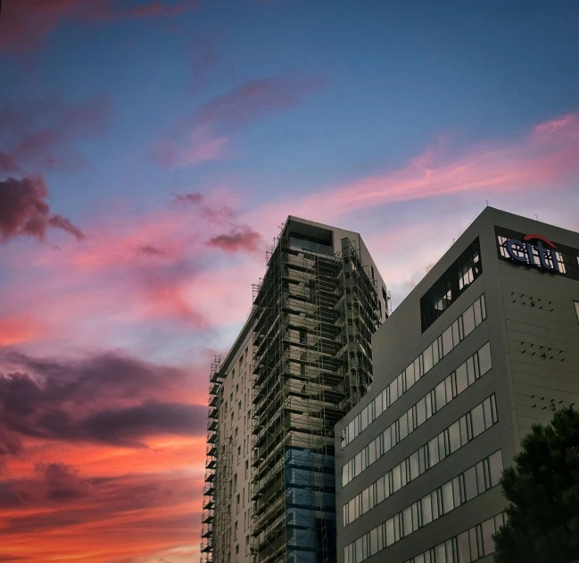 two high rise buildings against an evening sky