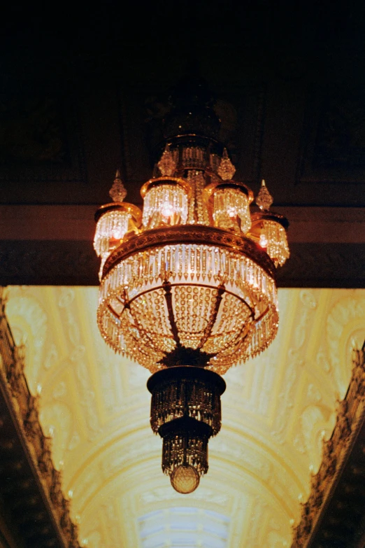 an ornate light fixture suspended from the ceiling of a building