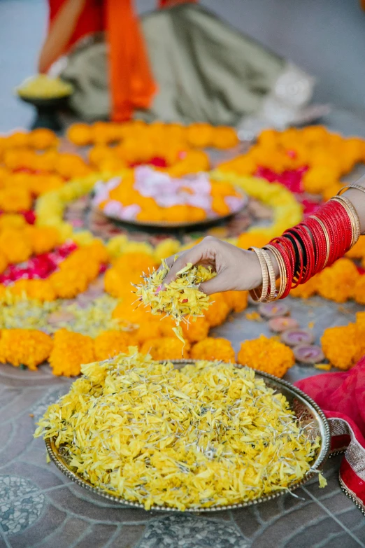 an indian woman serving food from a platter