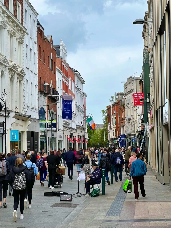 a busy shopping street with people shopping in it