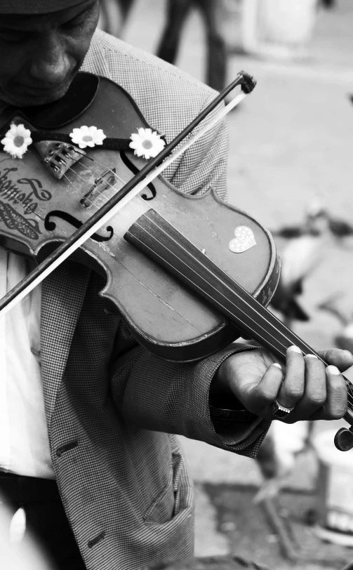 black and white image of a violin being played by a 