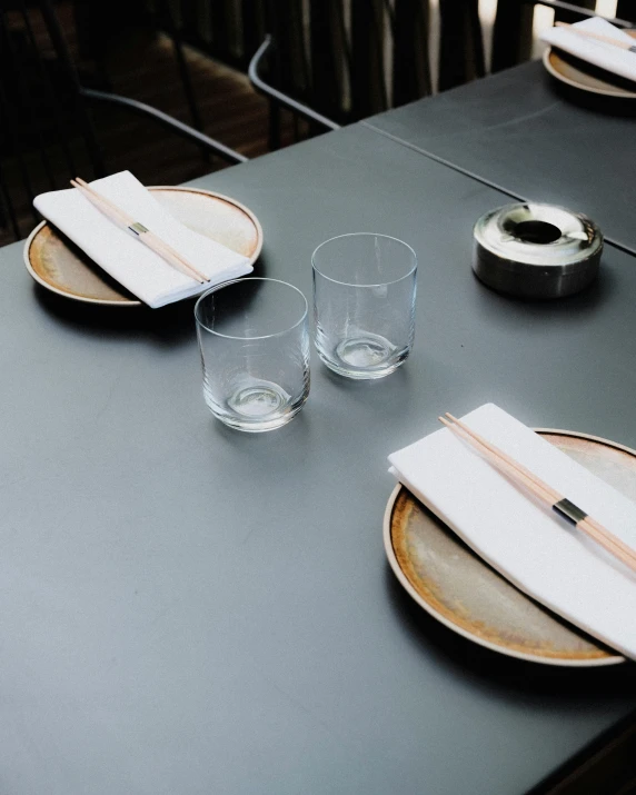 a table has empty glasses and plates on it