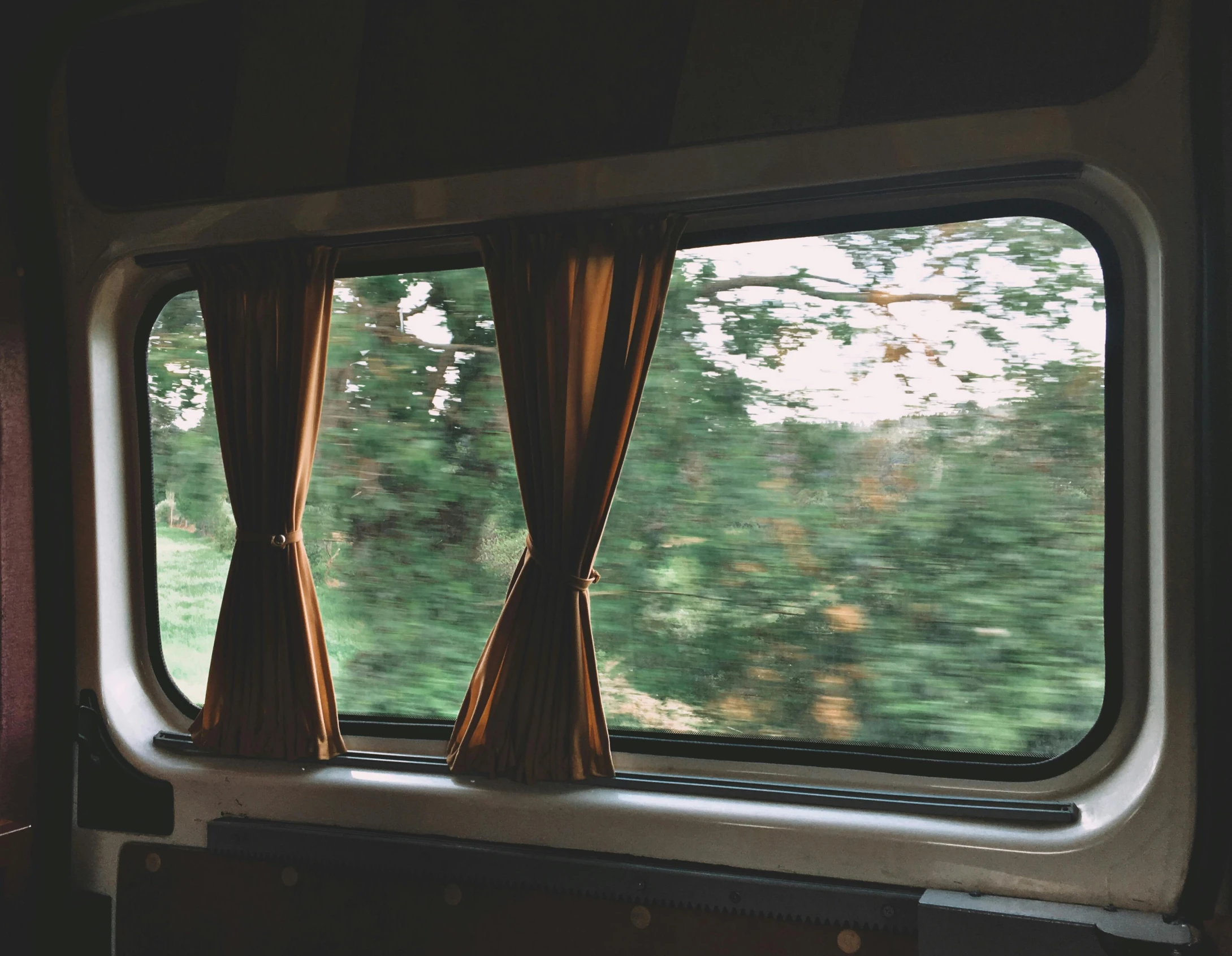 a train window is shown overlooking the outside