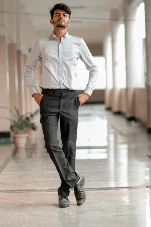 a man is standing in the hallway and posing for a pograph