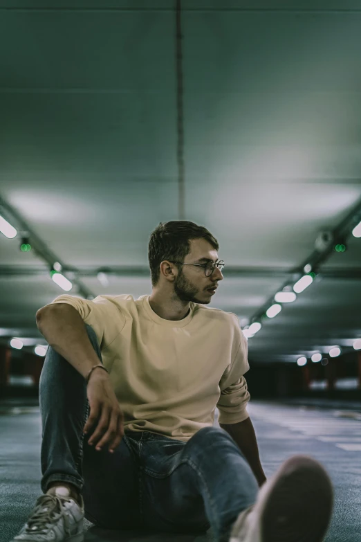 a man sitting on the floor with his legs crossed