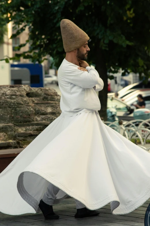 a person in a white coat walking on a street