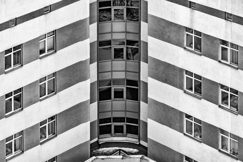 a tall building with many windows and shutters