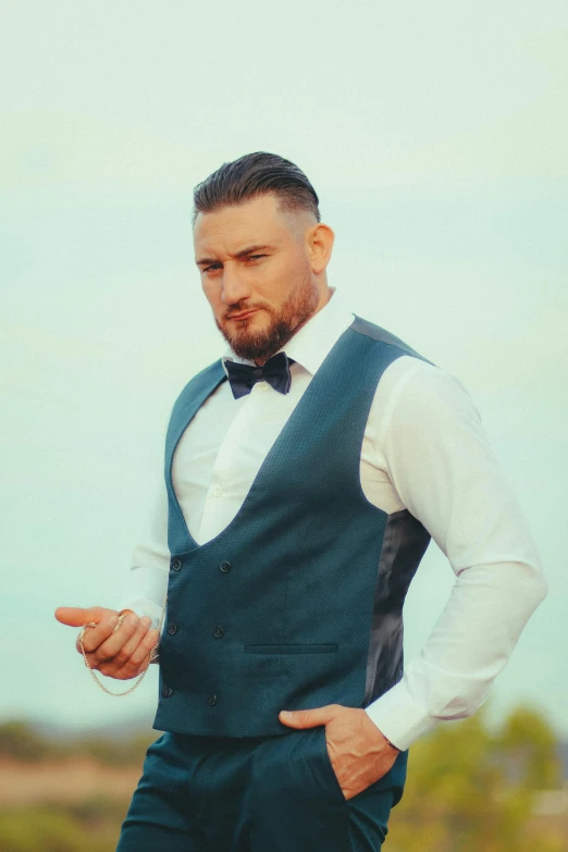 man with beard in a vest with a bow tie