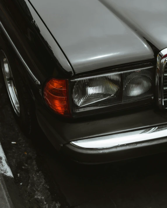 the tail light of a car parked on a city street