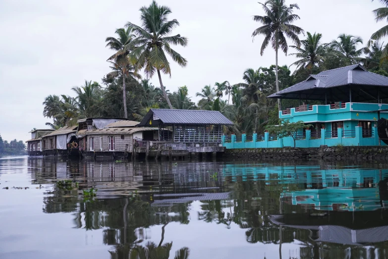 there is some huts on stilts in the water