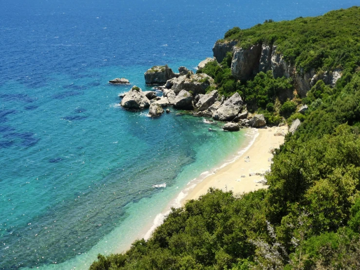 a large white sandy beach next to the ocean